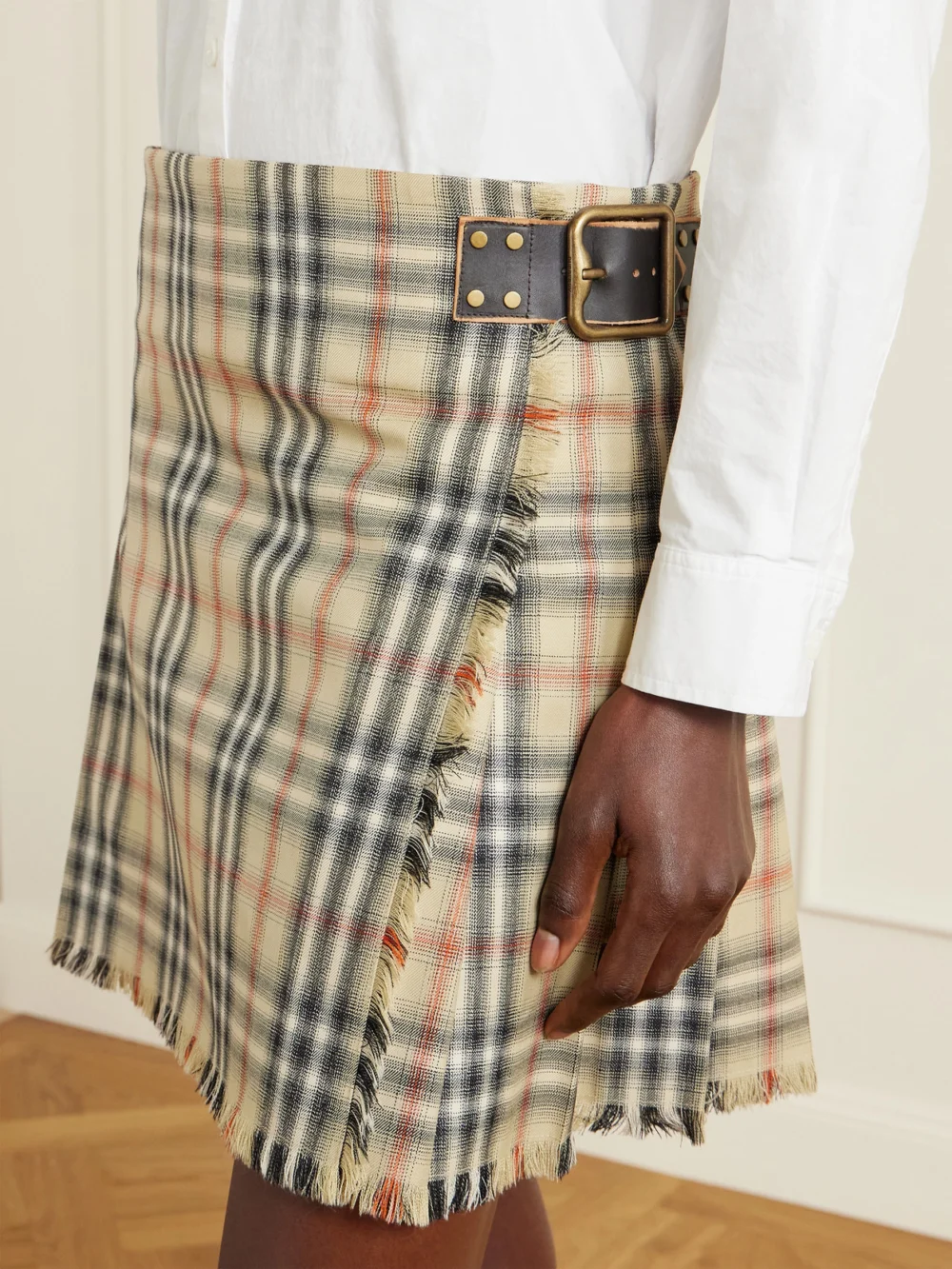 Close-up detail of the Burberry Leather-trimmed Pleated Checked Wool Mini Skirt