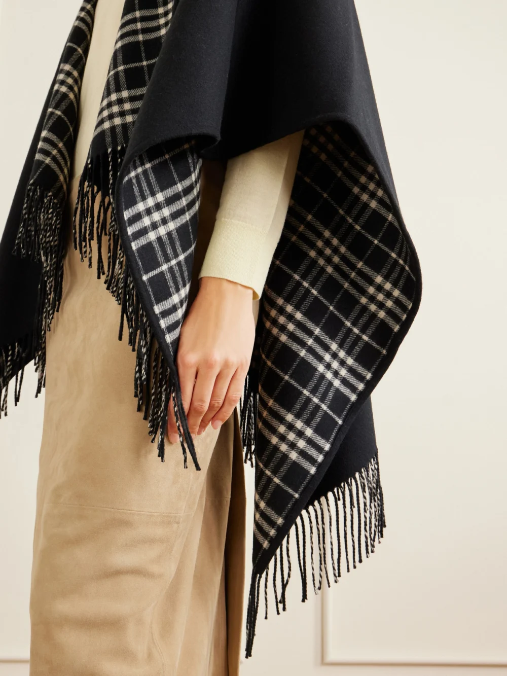Close-up detail of the Burberry Reversible Fringed Checked Wool Cape