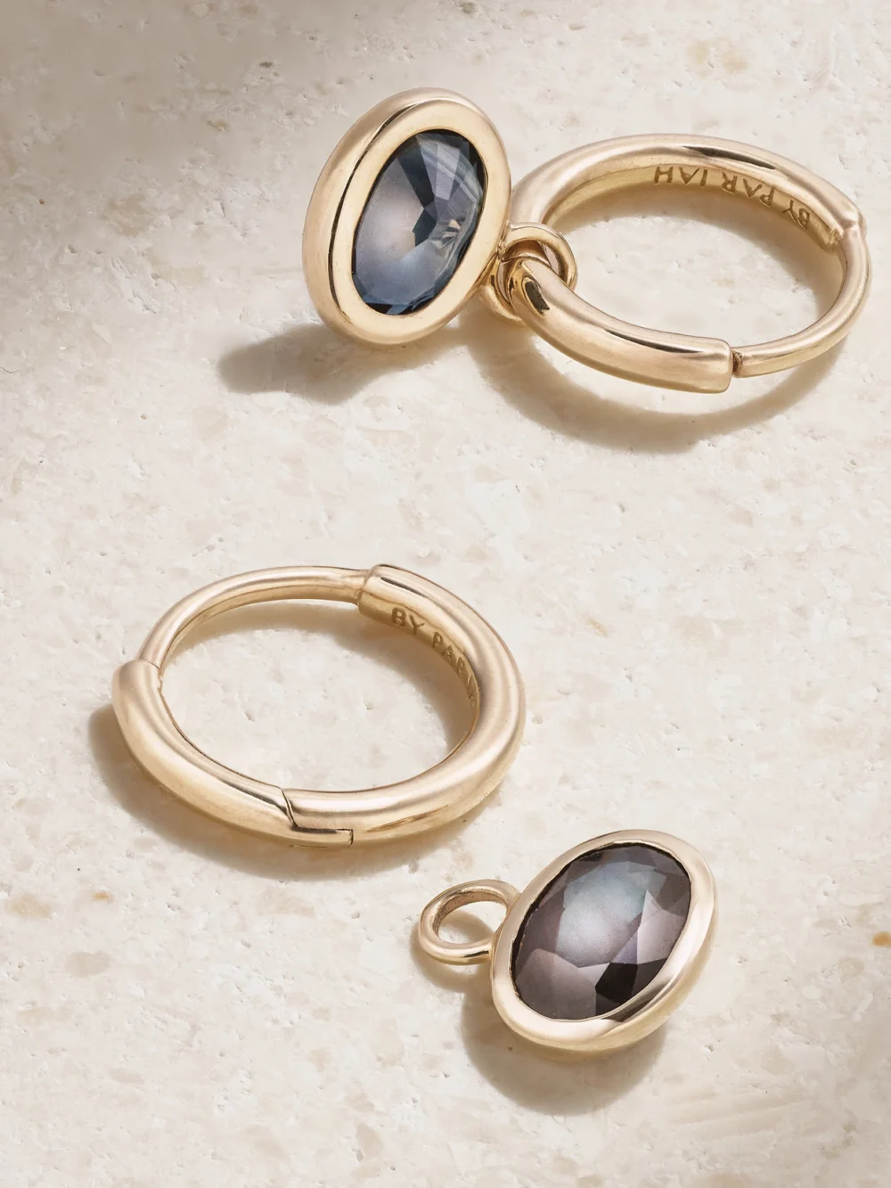 Close-up detail of the By Pariah Orbit 14-karat Recycled Gold Sapphire Hoop Earrings