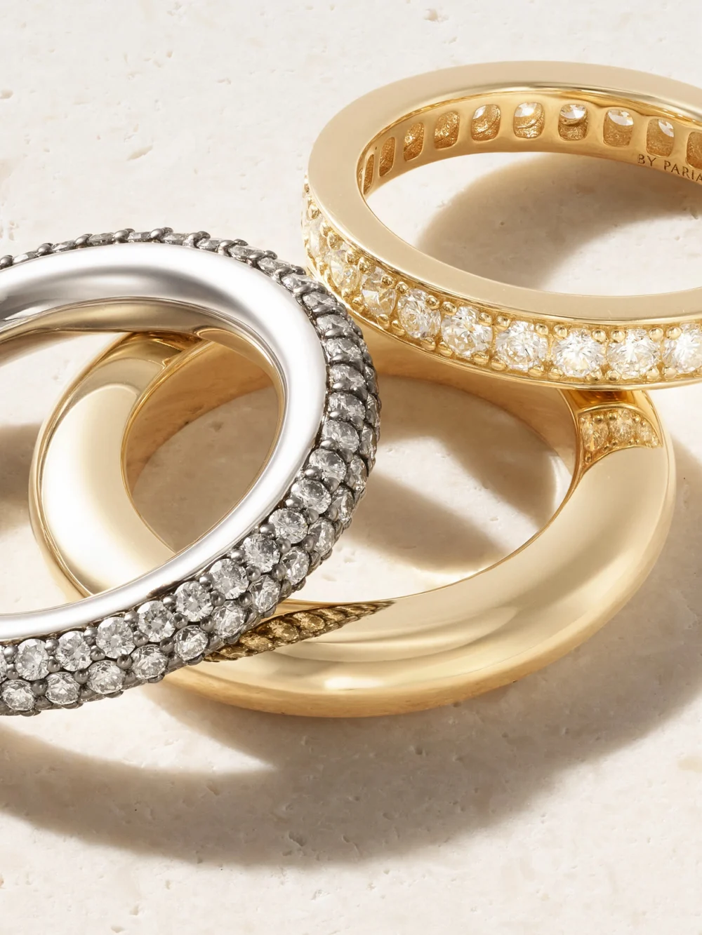 Close-up detail of the By Pariah Set of Three 14-karat Recycled Yellow and White Gold Diamond Rings