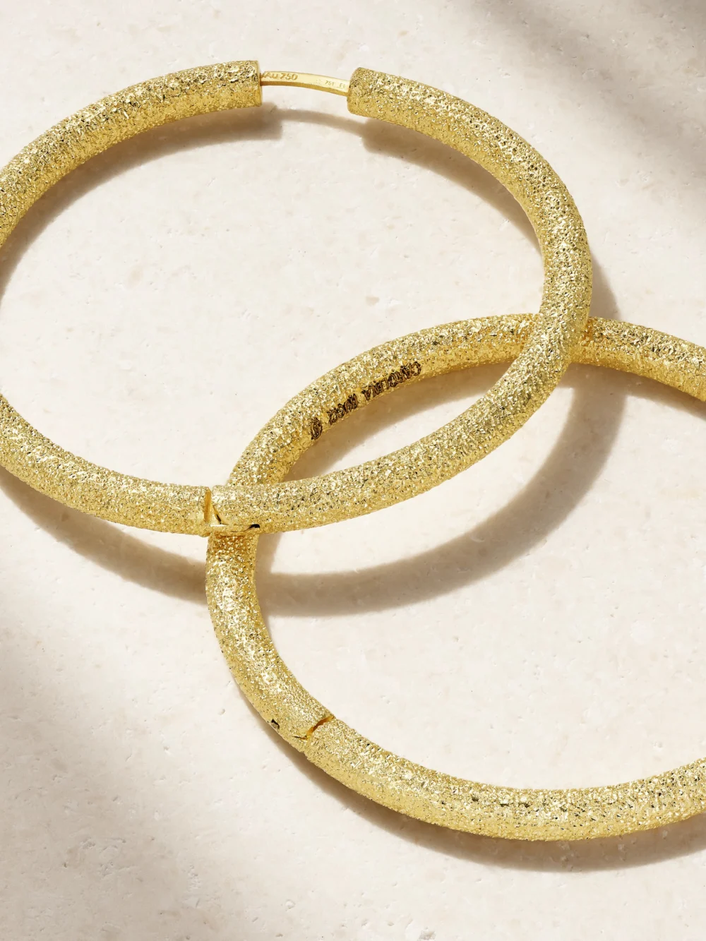 Close-up detail of the Carolina Bucci Florentine Finish Large 18-karat Gold Hoop Earrings