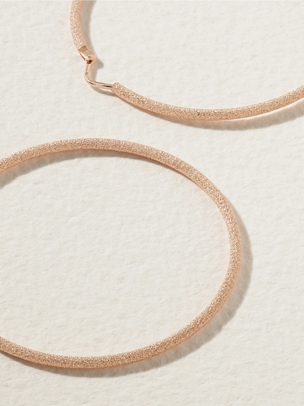 Close-up detail of the Carolina Bucci Florentine Finish Medium 18-karat Rose Gold Hoop Earrings