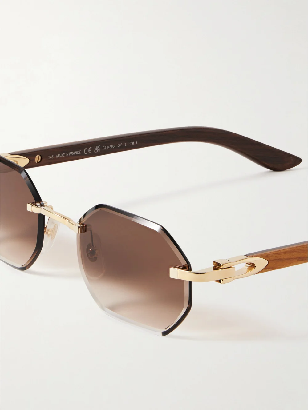 Close-up detail of the Cartier Eyewear Octagon-frame Gold-tone and Wood Sunglasses
