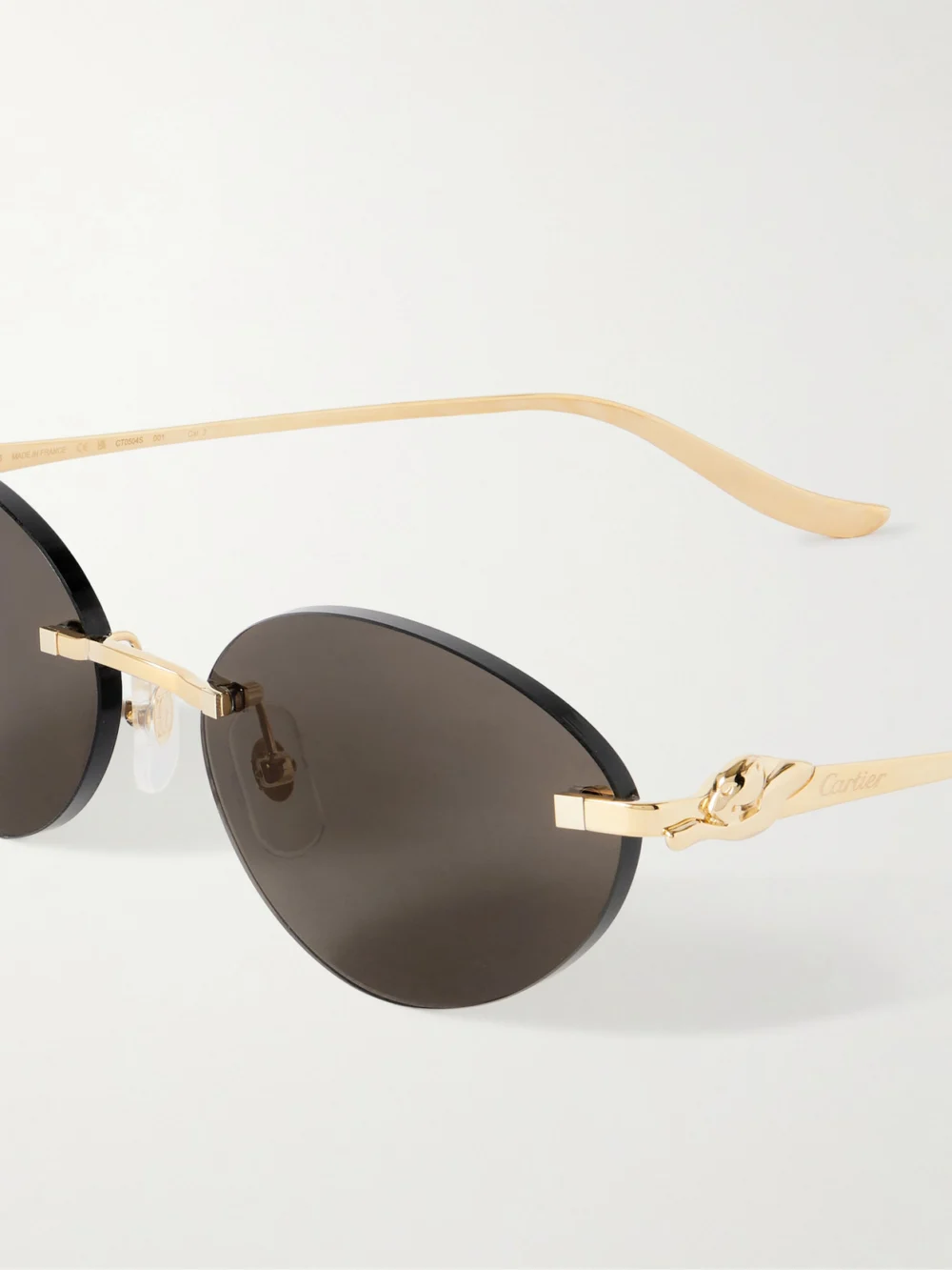 Close-up detail of the Cartier Eyewear Panthère Cat-eye Gold-tone Sunglasses