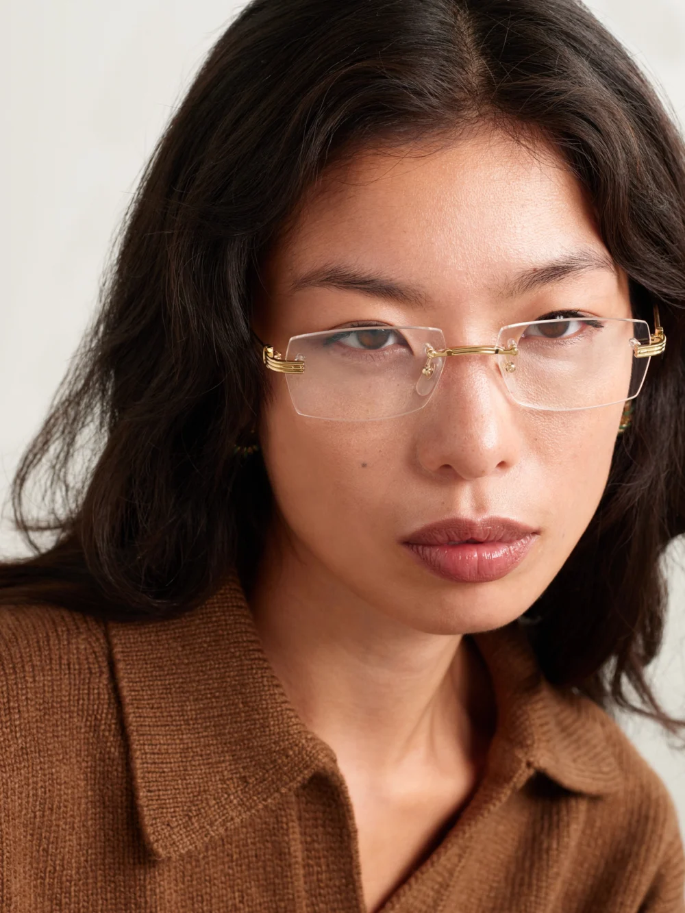 Cartier Eyewear Panthère Classic Rimless Oval-frame Gold-tone Optical Glasses, styled view