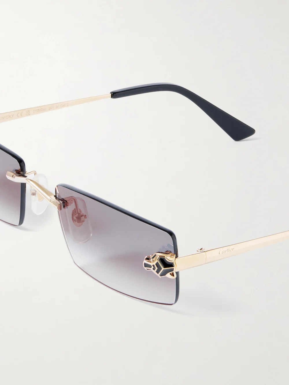 Close-up detail of the Cartier Eyewear Panthère Classic Rimless Rectangle-frame Gold-tone Sunglasses
