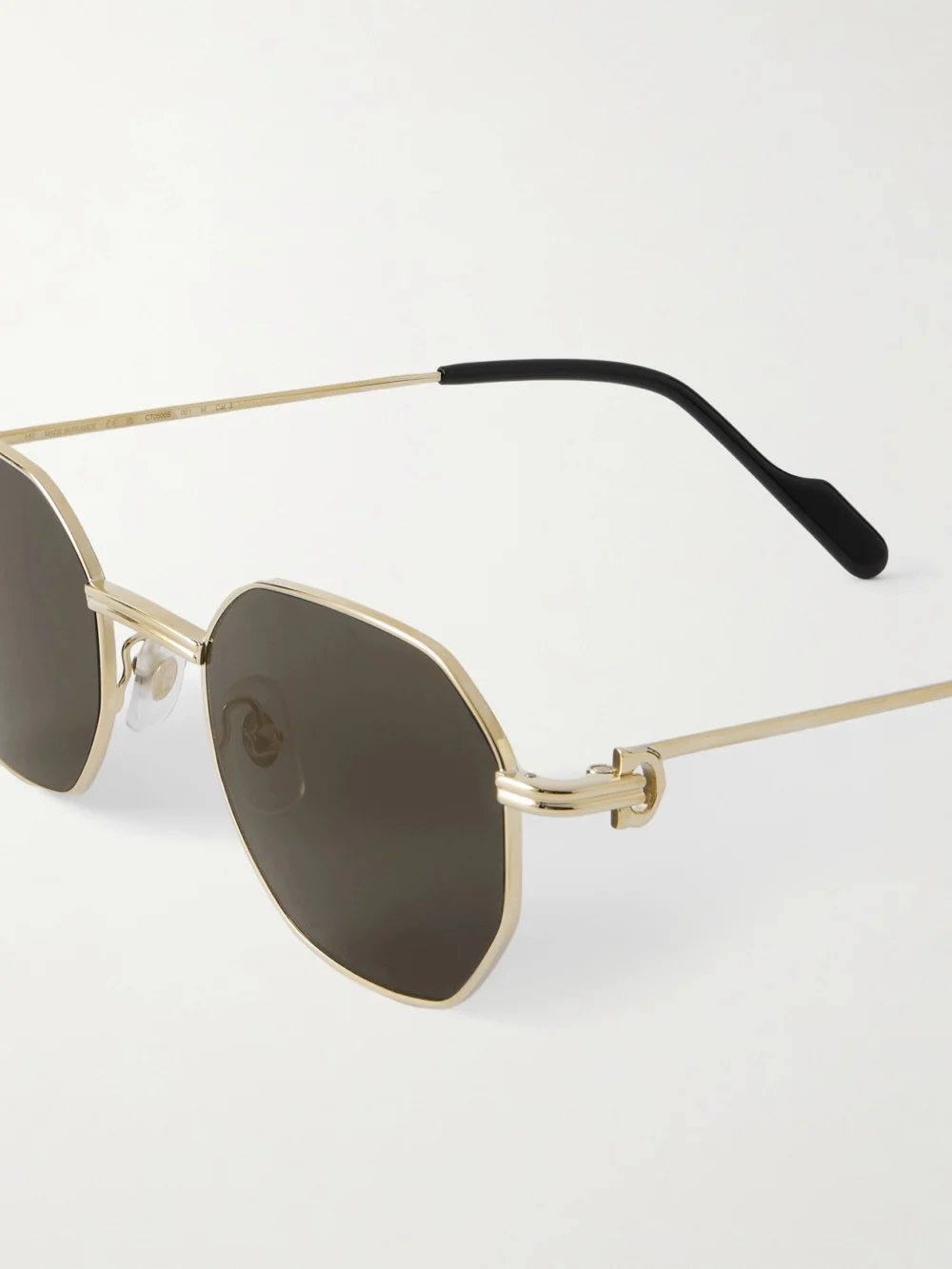 Close-up detail of the Cartier Eyewear Première De Cartier Hexagon-frame Gold-tone Sunglasses