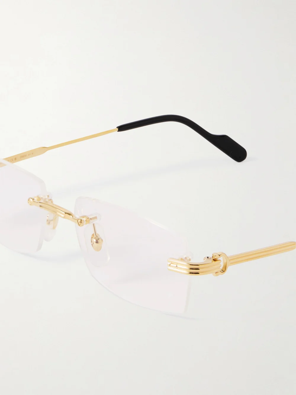 Close-up detail of the Cartier Eyewear Première De Cartier Rimless Rectangle-frame Gold-tone Optical Glasses
