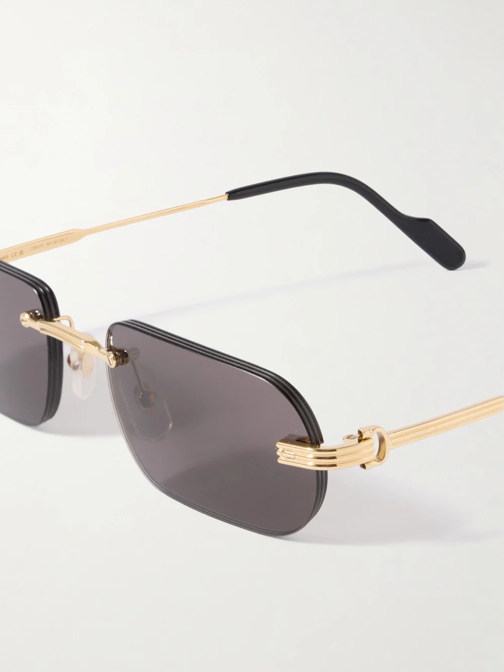 Close-up detail of the Cartier Eyewear Première De Cartier Rimless Rectangle-frame Gold-tone Sunglasses