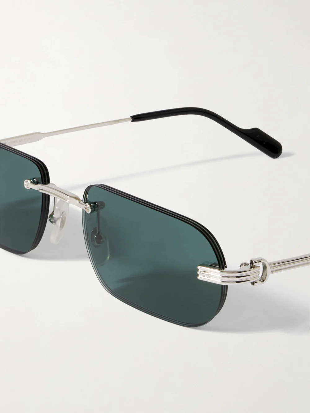 Close-up detail of the Cartier Eyewear Première De Cartier Rimless Rectangular-frame Silver-tone Sunglasses