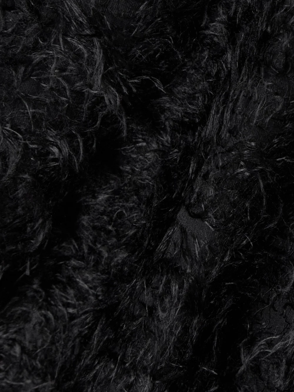 Close-up detail of the Carven Belted Faux-shearling Coat