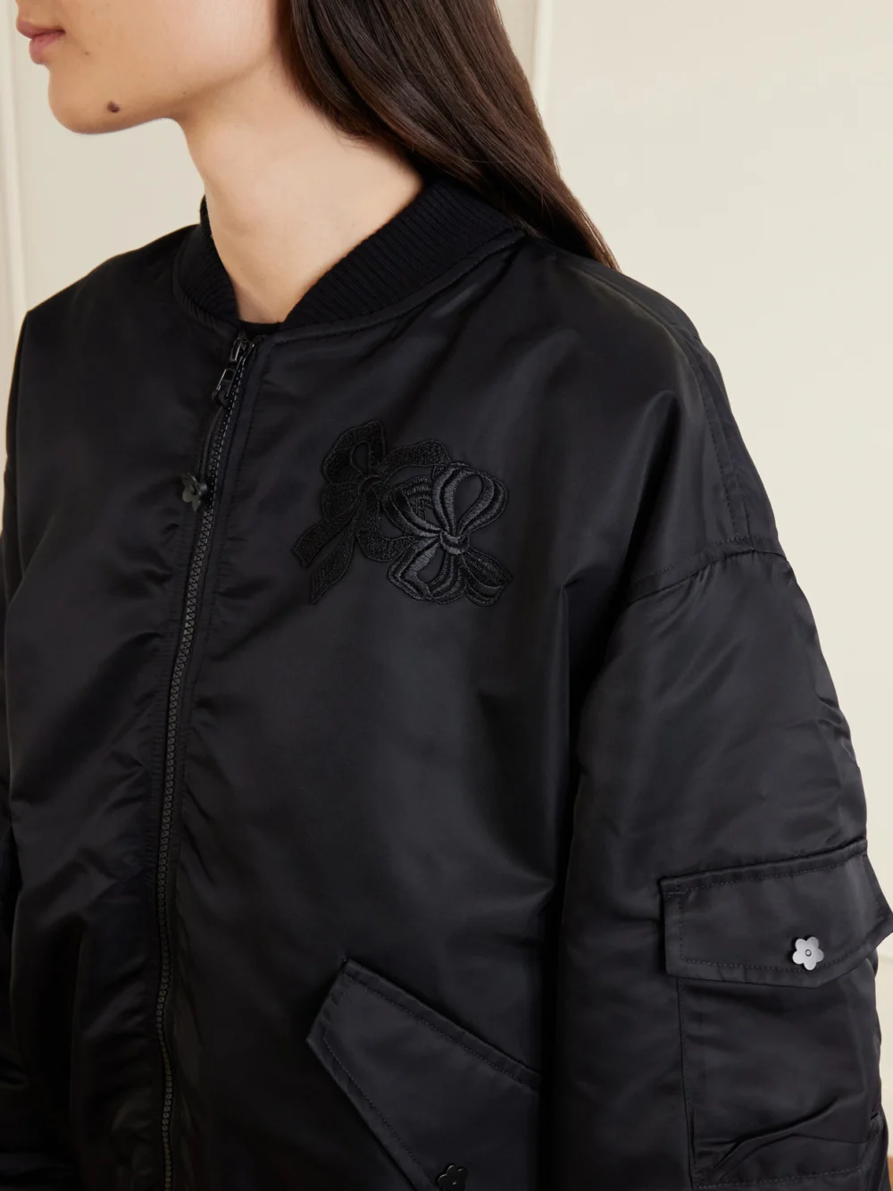 Close-up detail of the Cecilie Bahnsen Cbfeilan Knotted Embroidered Shell Bomber Jacket