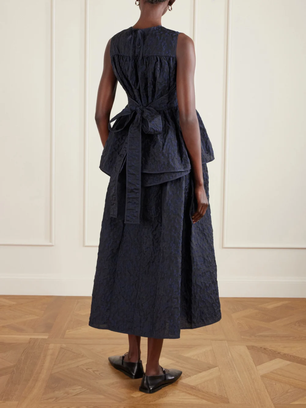 Back view of the Cecilie Bahnsen Margueritte Embroidered Cotton-blend Cloqué Peplum Top