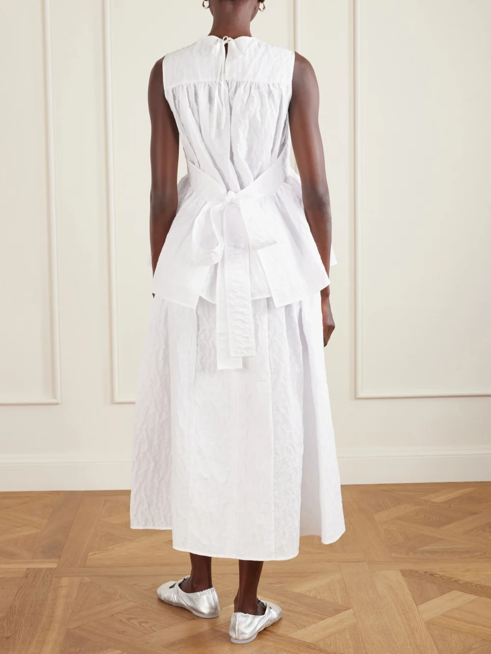 Back view of the Cecilie Bahnsen Margueritte Embroidered Cotton-blend Cloqué Peplum Top