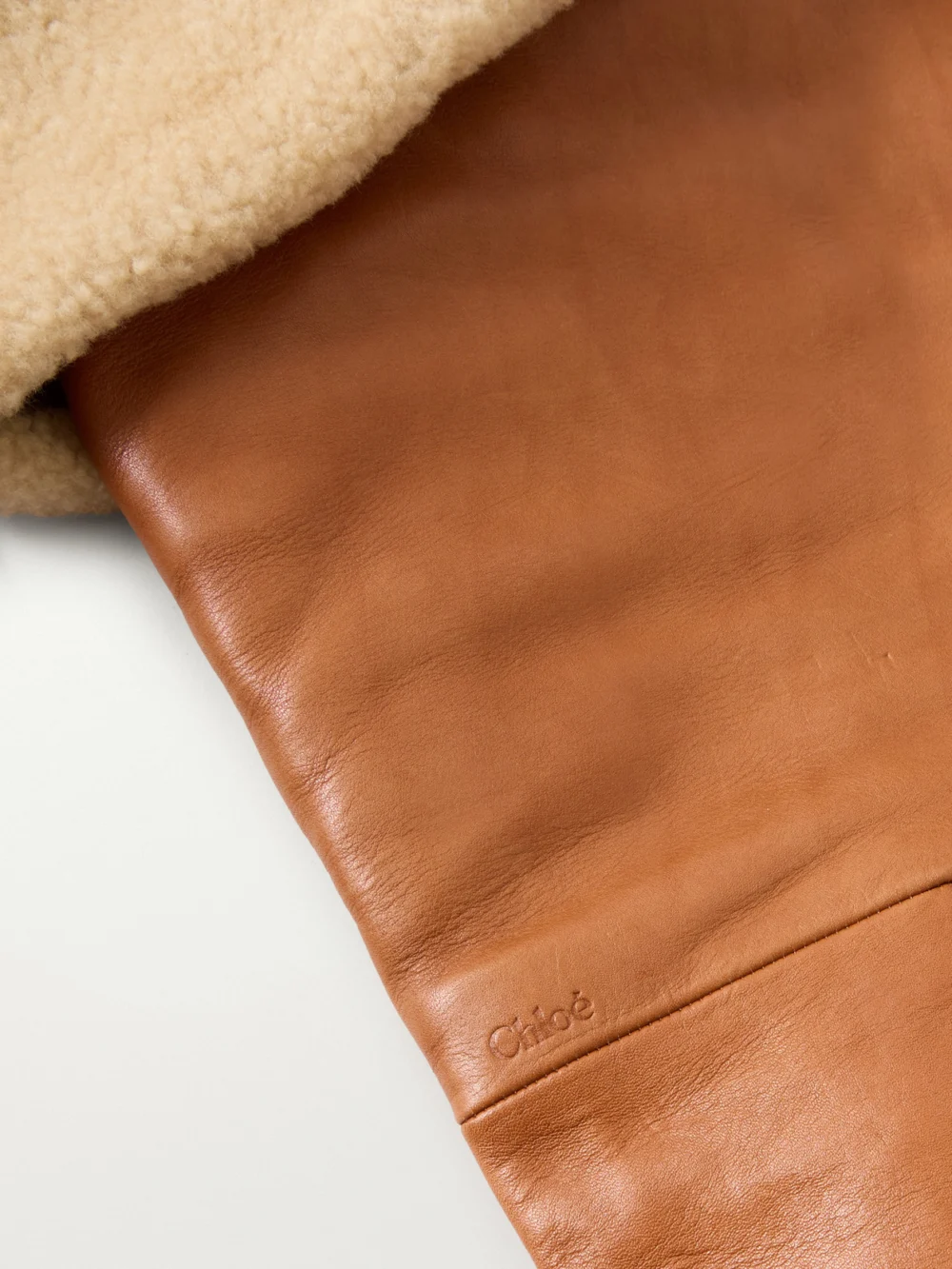 Close-up detail of the Chloé Azalean Shearling-trimmed Leather Over-the-knee Boots