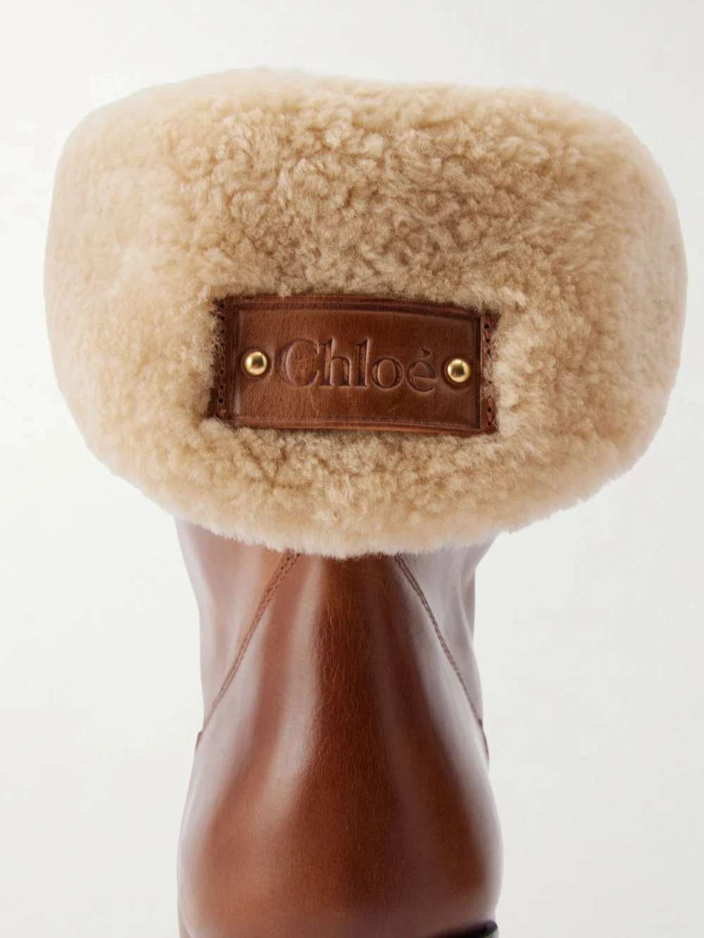 Close-up detail of the Chloé Azelan Shearling-trimmed Leather Ankle Boots