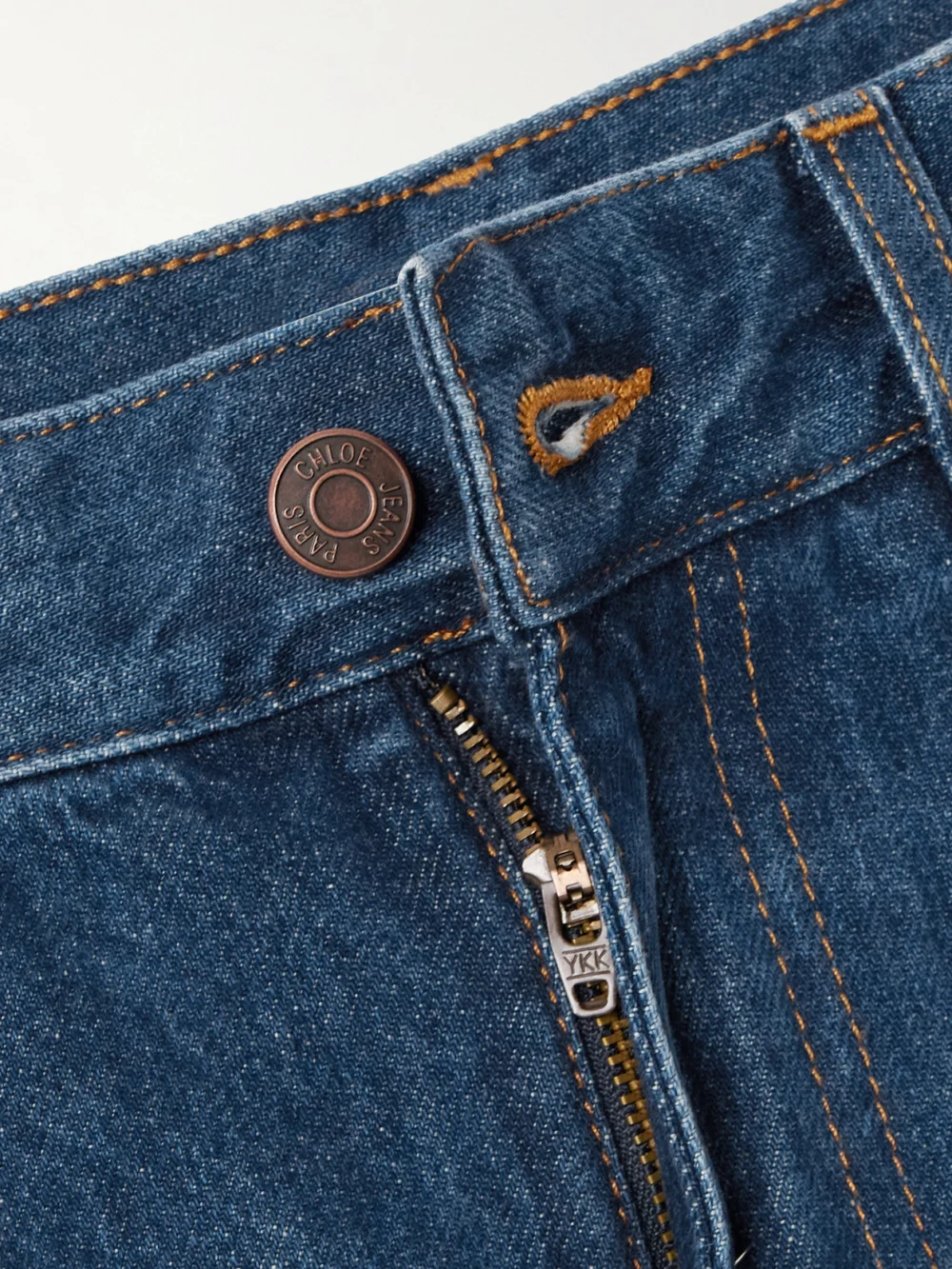 Close-up detail of the Chloé Cropped Distressed High-rise Wide-leg Jeans