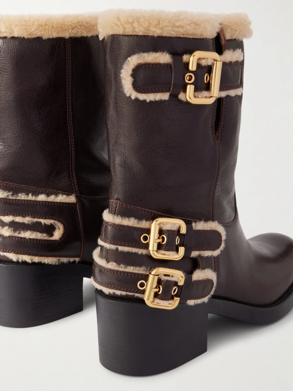 Close-up detail of the Chloé Dakota Buckled Shearling-trimmed Leather Ankle Boots