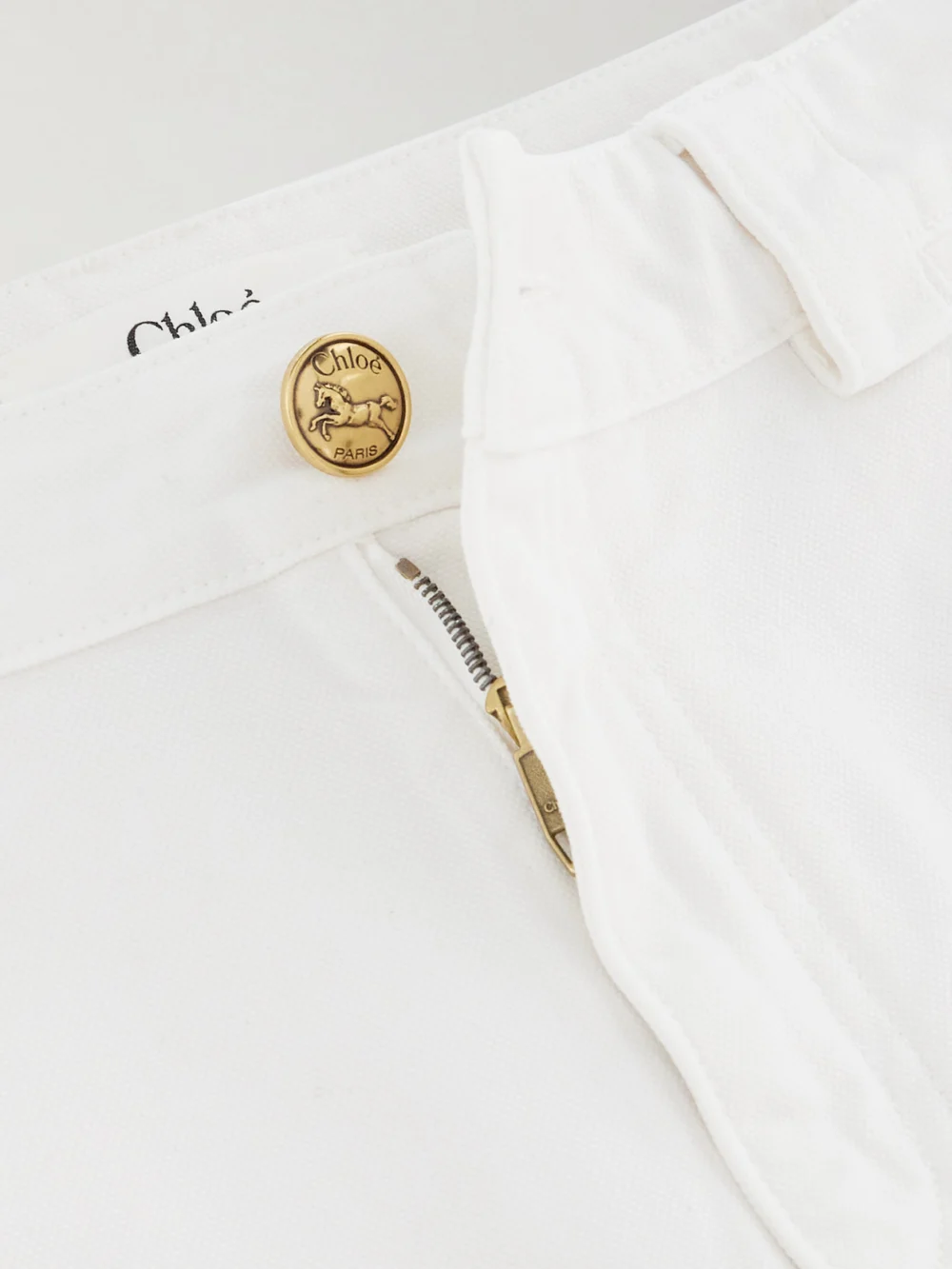 Close-up detail of the Chloé Embellished Mid-rise Straight-leg Jeans