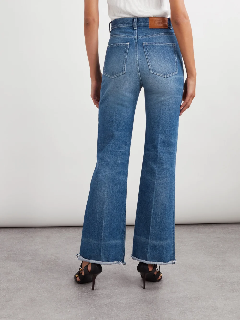 Back view of the Chloé Frayed High-rise Flared Jeans