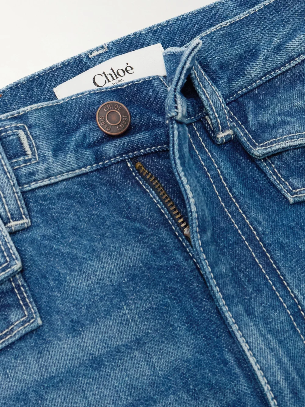 Close-up detail of the Chloé Frayed High-rise Flared Jeans