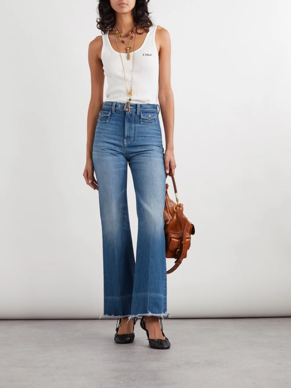 Chloé Frayed High-rise Flared Jeans, worn by a model