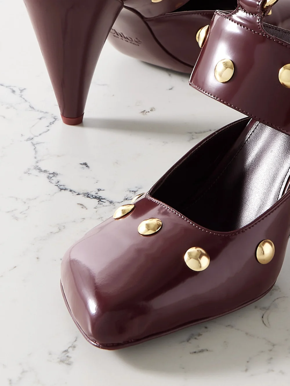 Close-up detail of the Chloé Jade Studded Patent-leather Pumps