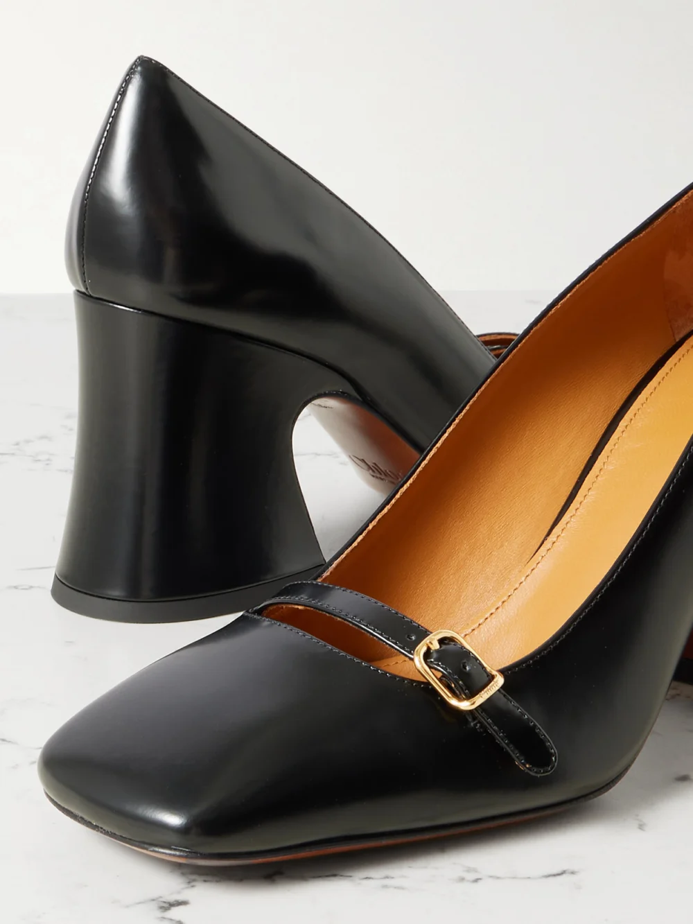 Close-up detail of the Chloé Janis Buckled Glossed-leather Pumps