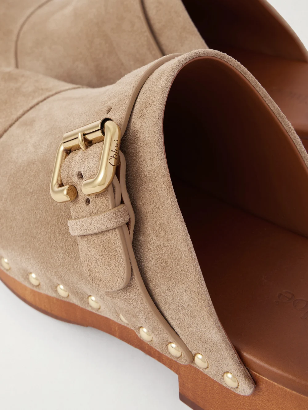 Close-up detail of the Chloé Jeannette Embellished Suede Clogs