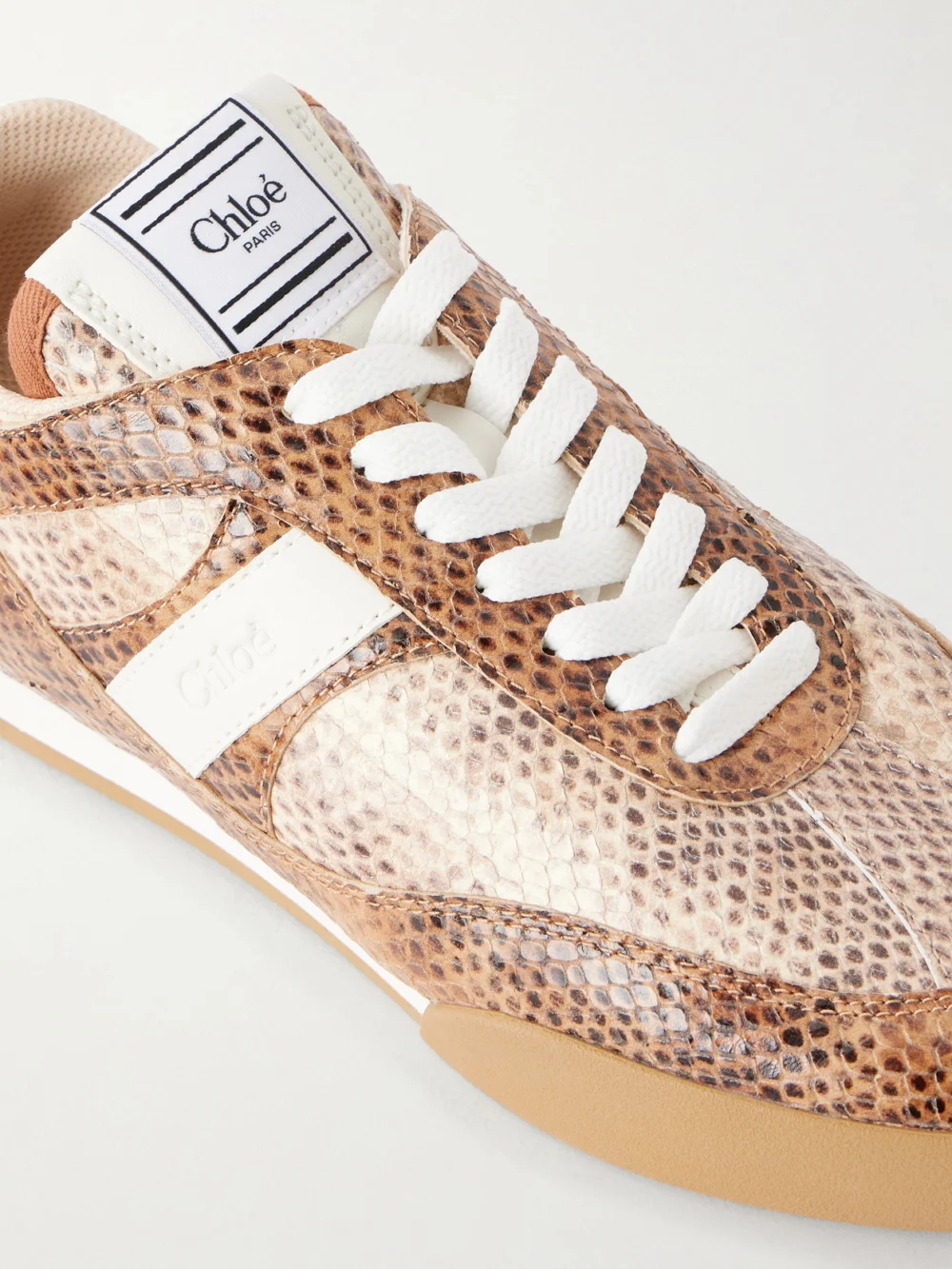 Close-up detail of the Chloé Kick Snake-effect Leather Low Top Sneakers