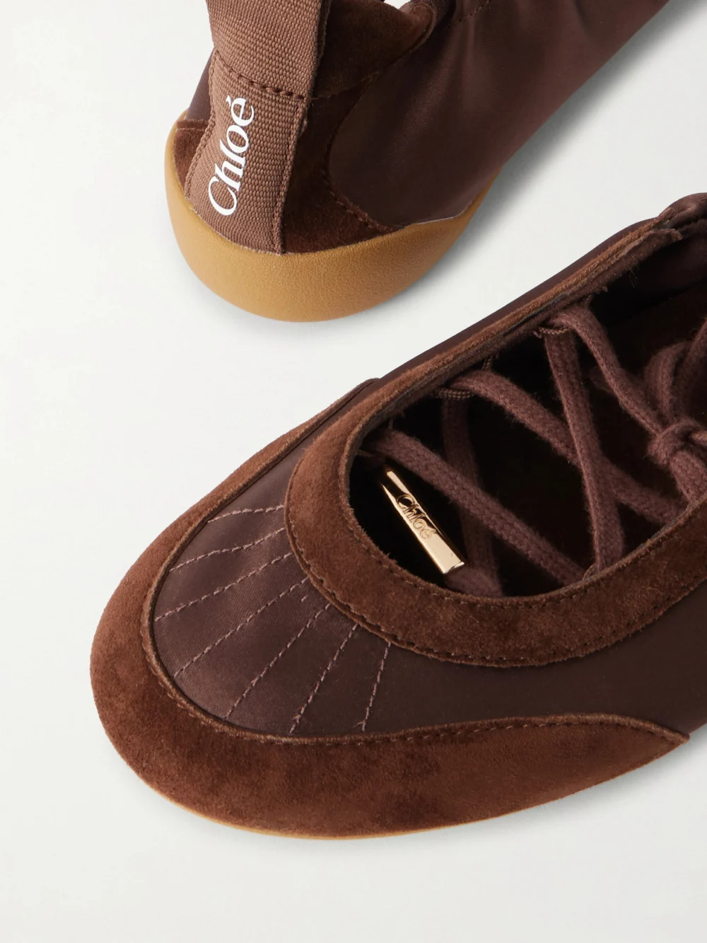 Close-up detail of the Chloé Kick Suede-trimmed Satin Sneakers