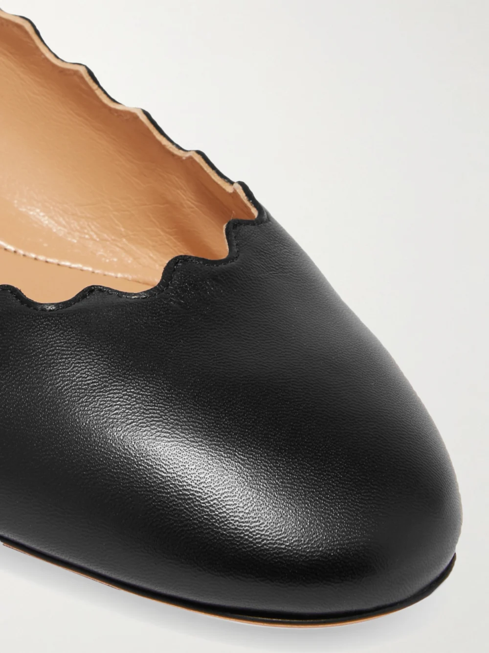 Close-up detail of the Chloé Lauren Scalloped Leather Ballet Flats