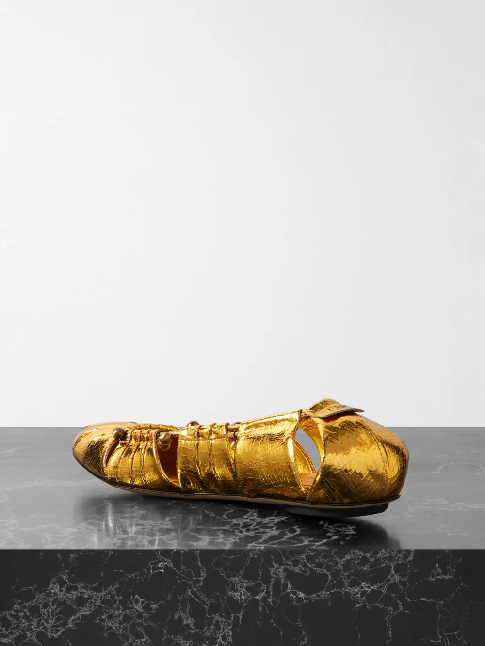 Back view of the Chloé Luna Cutout Embellished Gathered Metallic Leather Ballet Flats