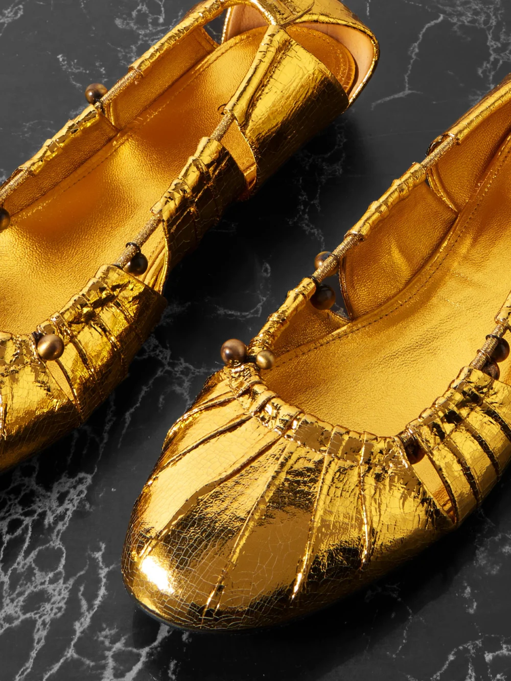 Close-up detail of the Chloé Luna Cutout Embellished Gathered Metallic Leather Ballet Flats