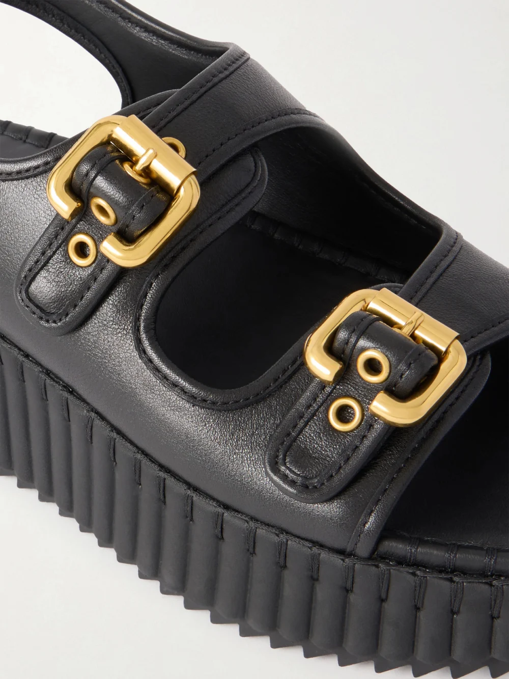 Close-up detail of the Chloé Nama Buckled Leather Wedge Sandals