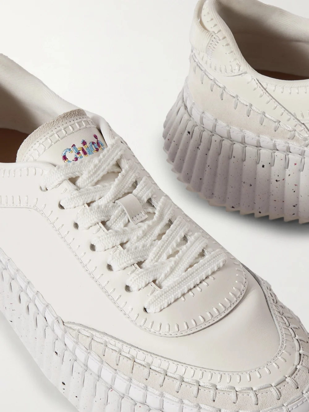 Close-up detail of the Chloé Nama Embroidered Suede-trimmed Leather Sneakers