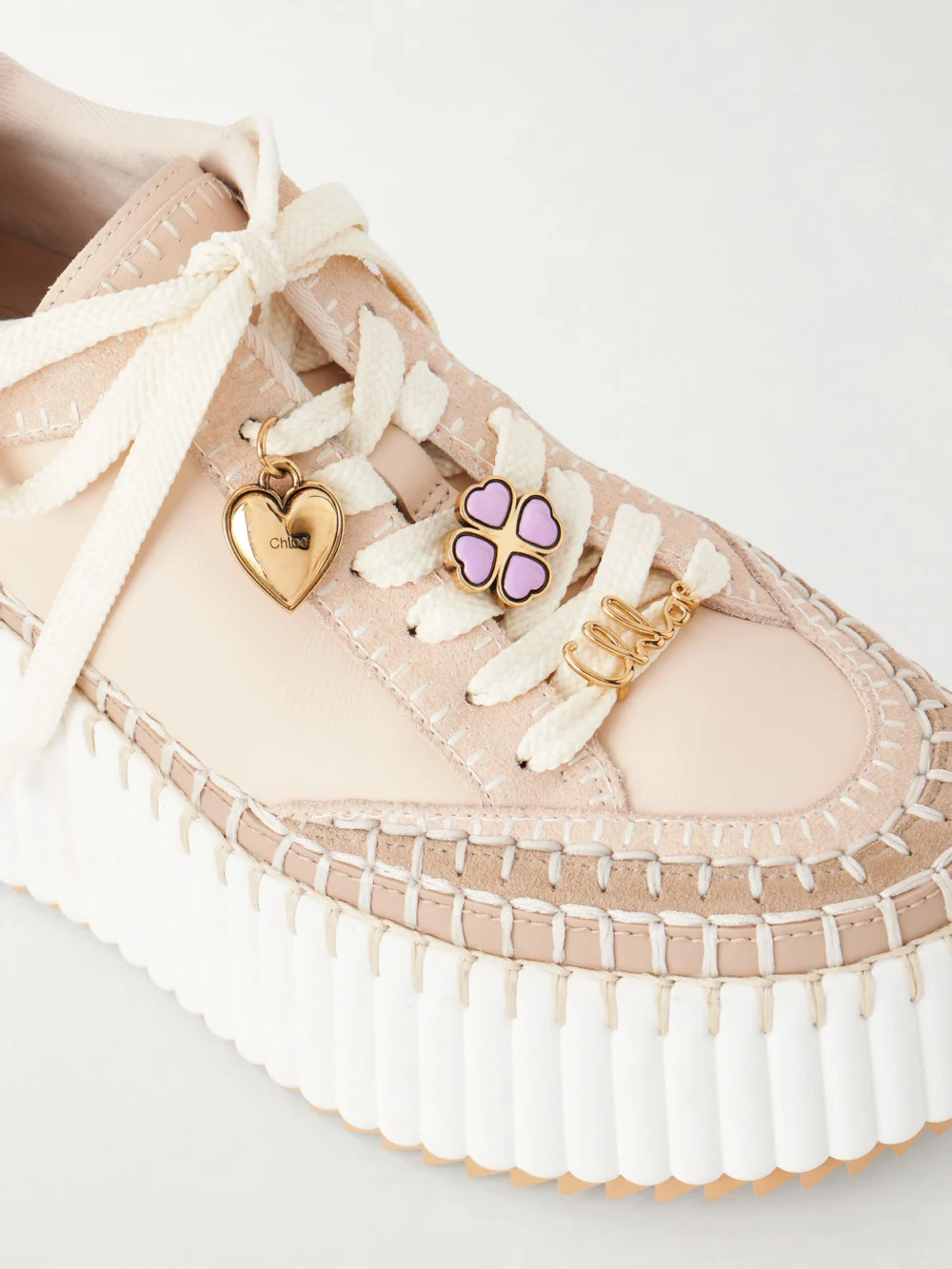 Close-up detail of the Chloé Nama Patchwork Suede-trimmed Leather Platform Sneakers