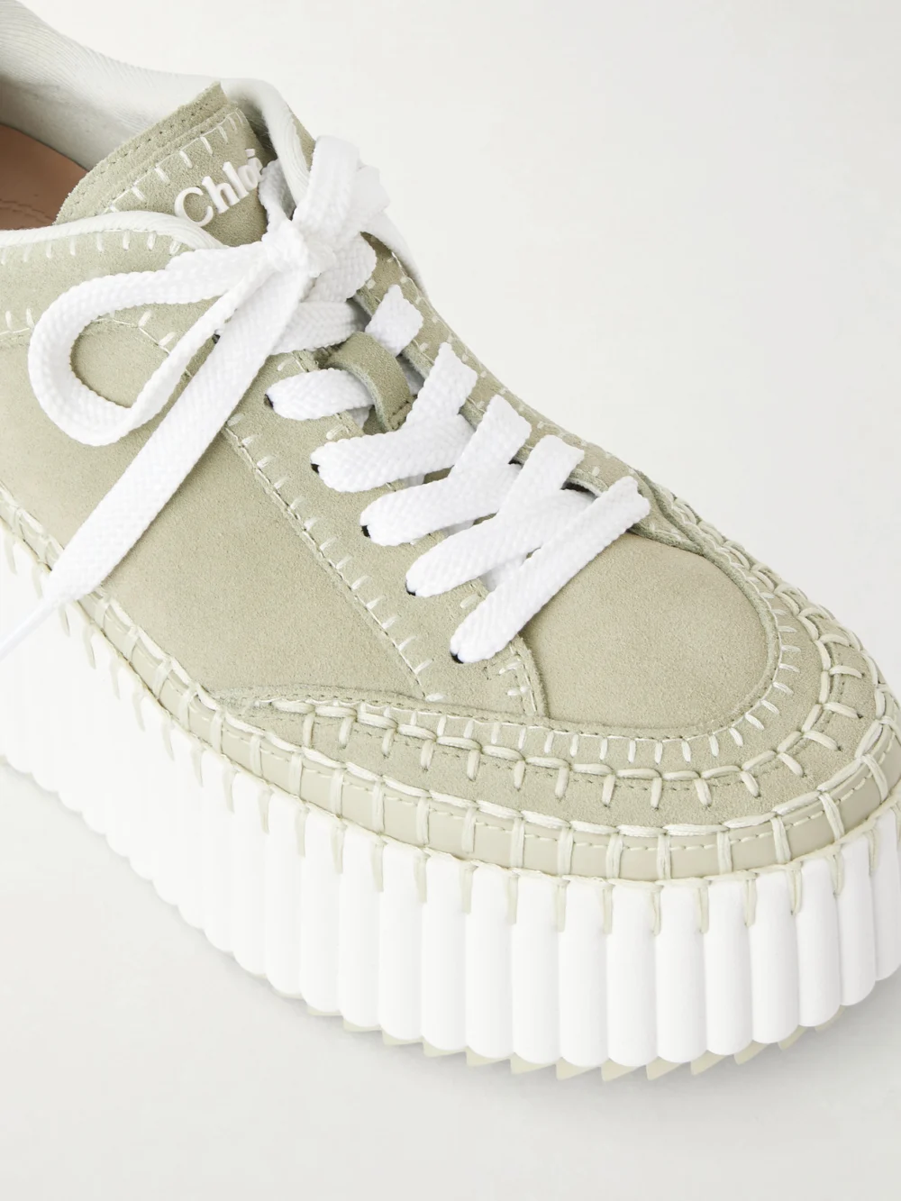 Close-up detail of the Chloé Nama Patchwork Suede-trimmed Leather Platform Sneakers