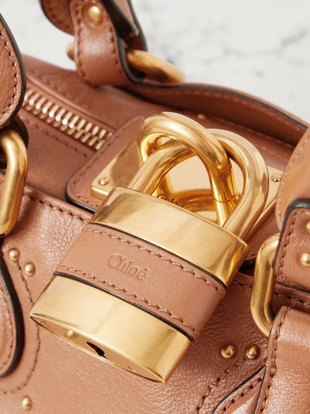 Close-up detail of the Chloé Paddington Embellished Leather Top-handle Bag