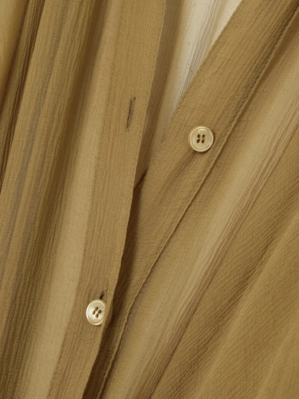 Close-up detail of the Chloé Pleated Organic Silk-mousseline Midi Shirt Dress
