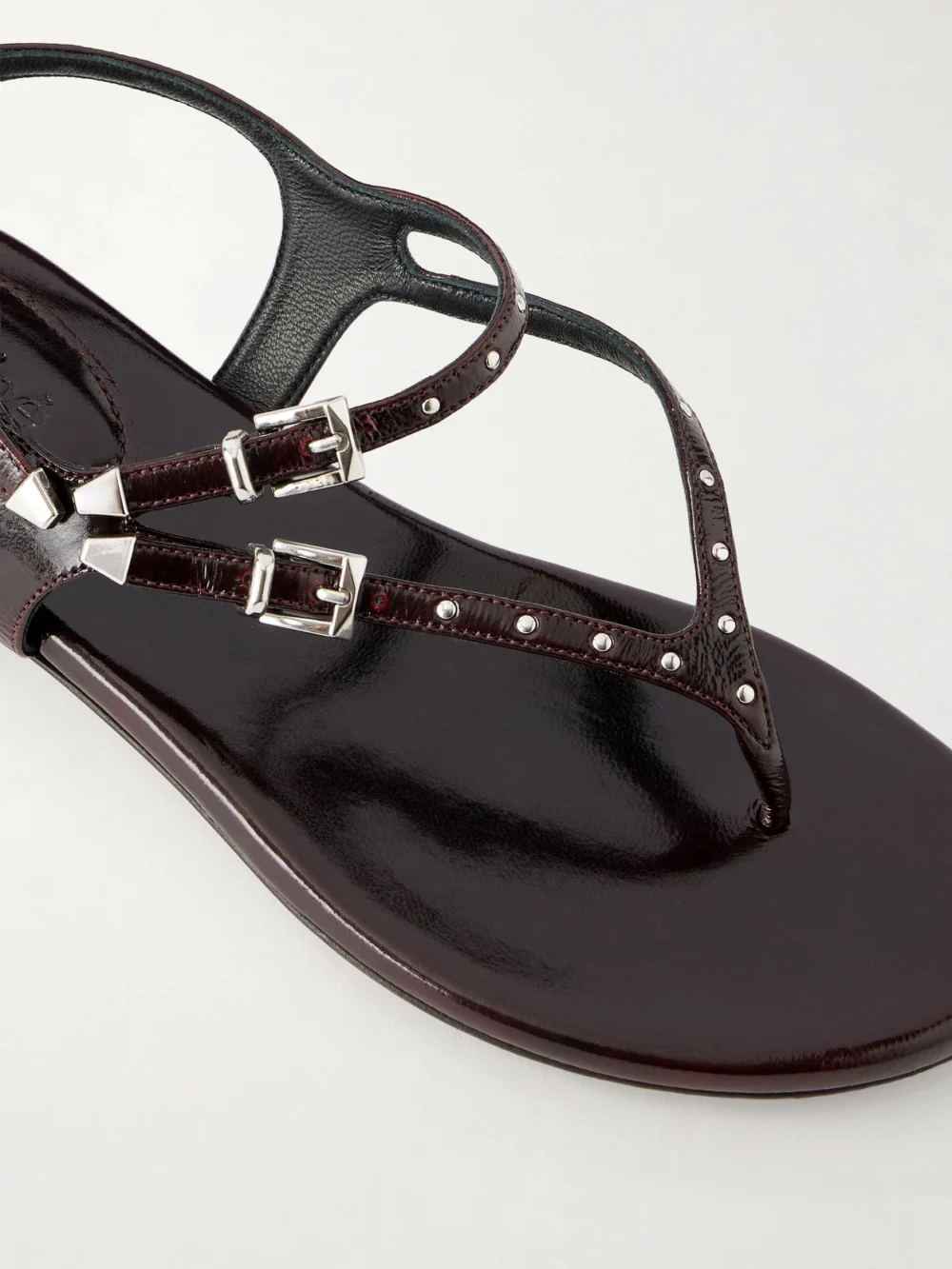Close-up detail of the Chloé Studded Patent Leather Sandals