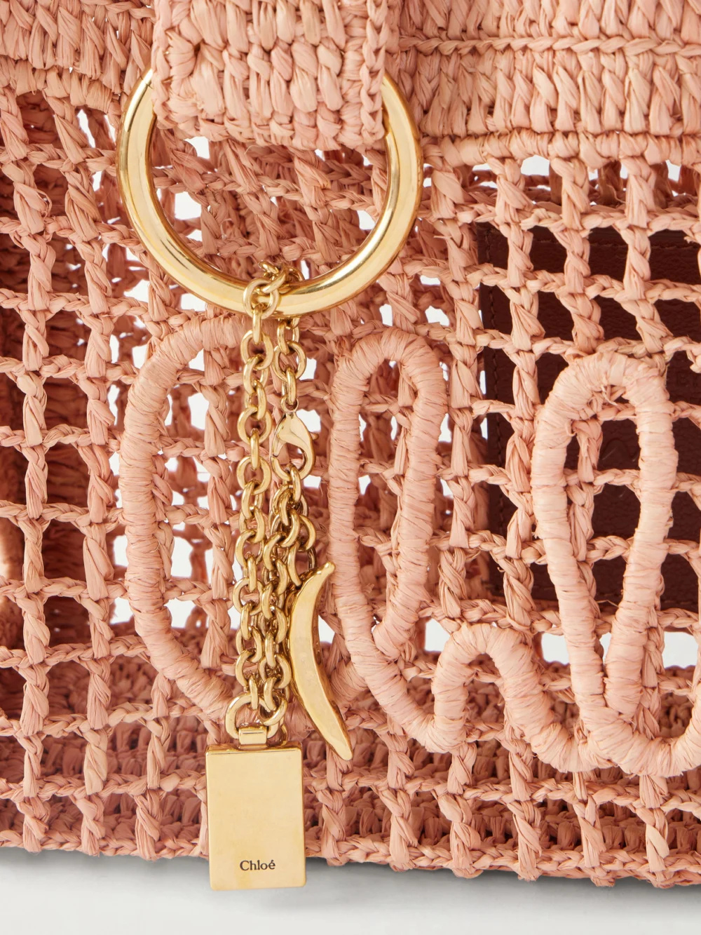 Close-up detail of the Chloé Summer Banana Leather-trimmed Raffia Tote Bag
