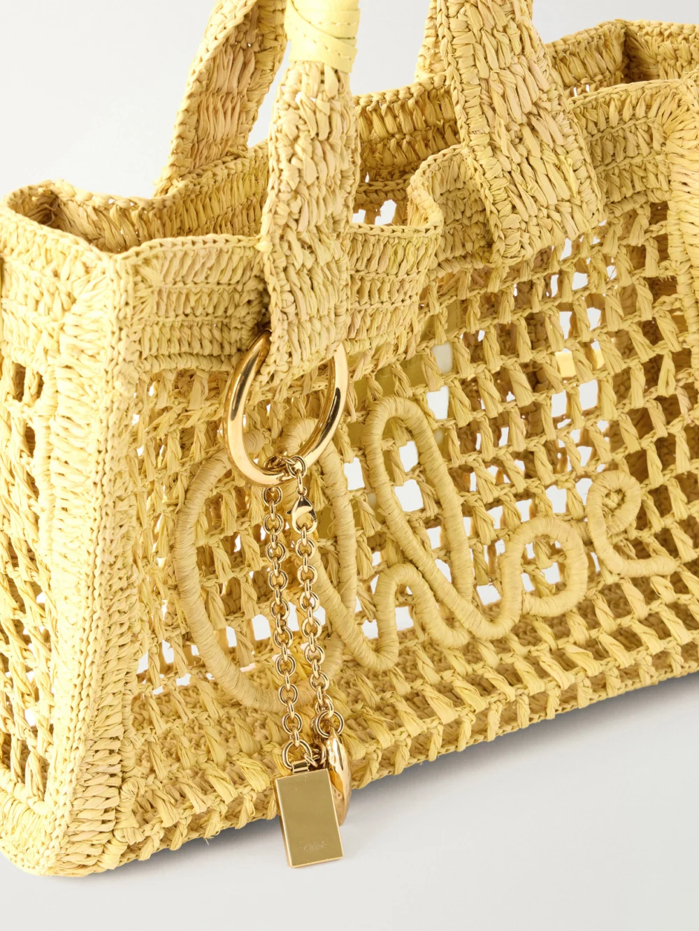 Close-up detail of the Chloé Summer Banana Leather-trimmed Raffia Tote Bag