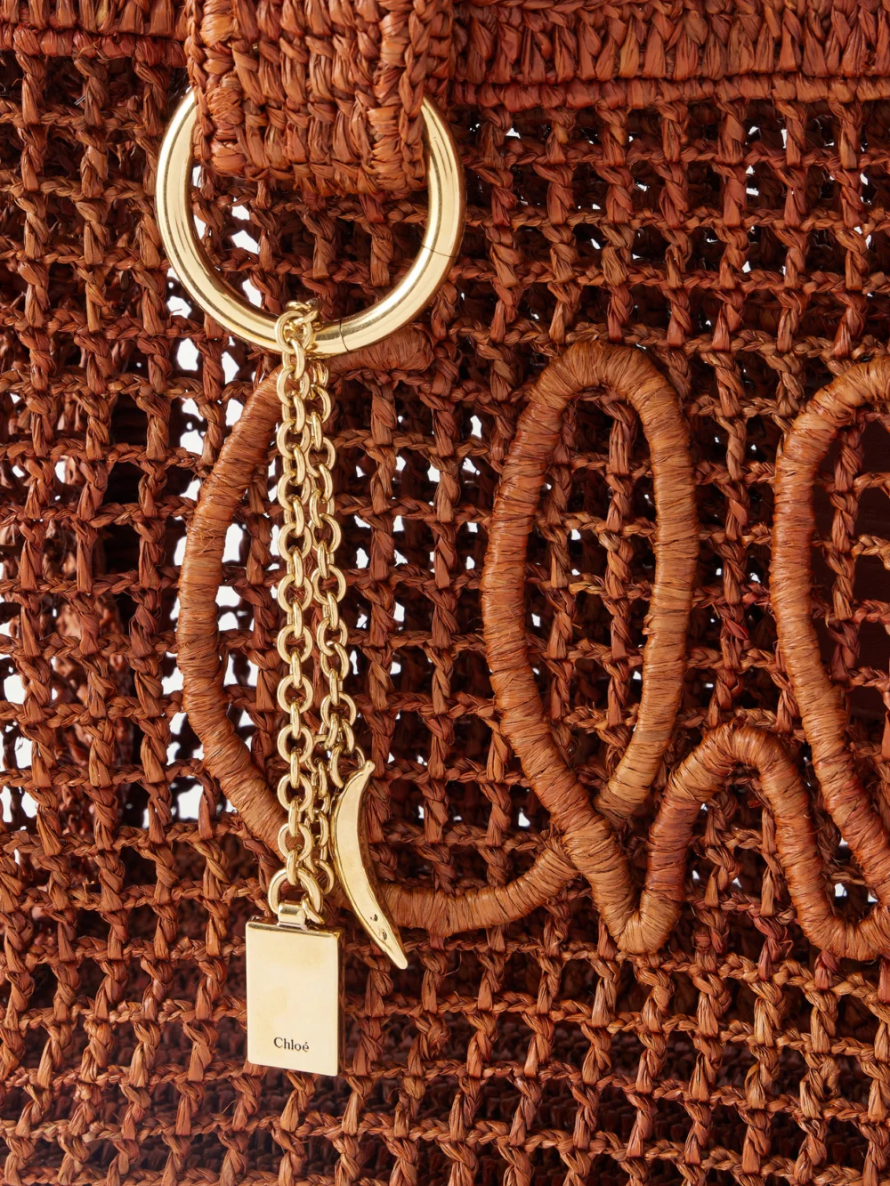Close-up detail of the Chloé Summer Banana Leather-trimmed Raffia Tote