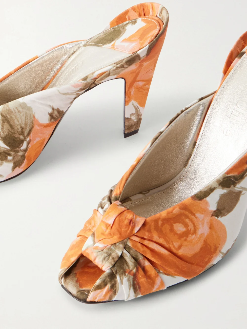 Close-up detail of the Chloé Suzie Ruched Floral-print Satin Sandals