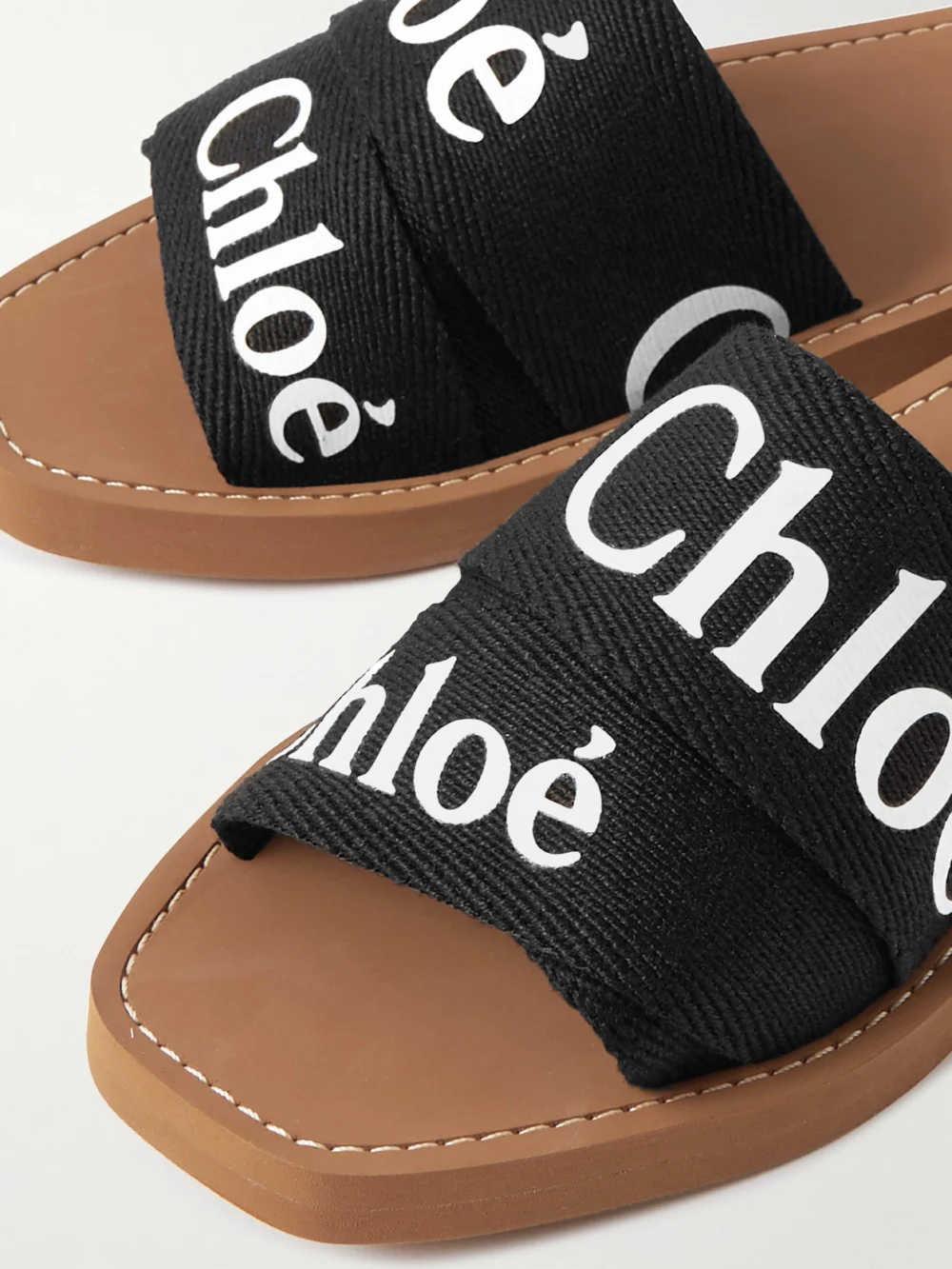 Close-up detail of the Chloé Woody Logo-print Canvas Slides