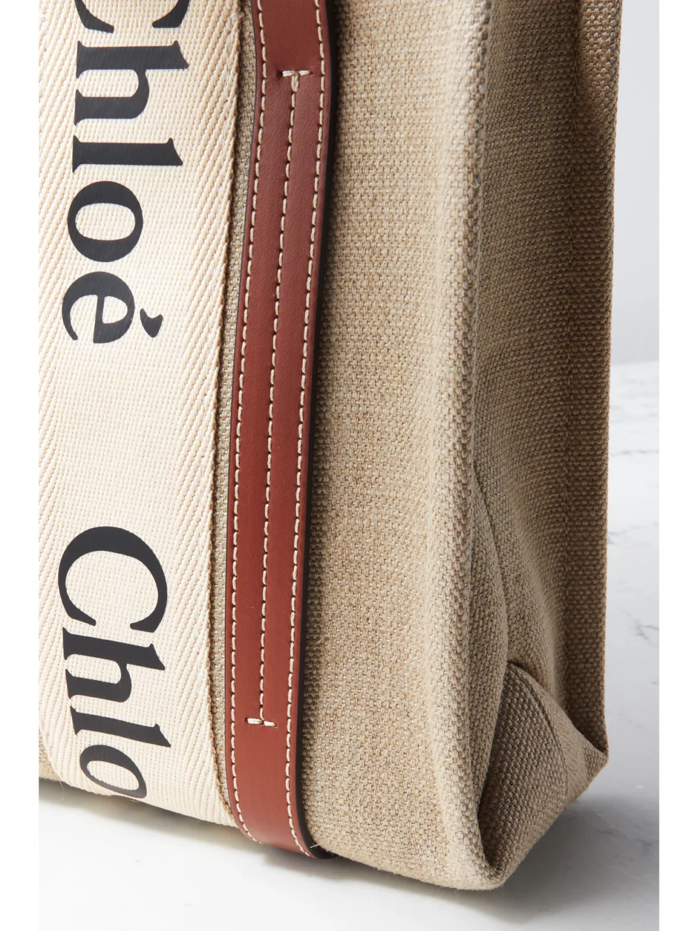 Close-up detail of the Chloé Woody Small Embroidered Leather-trimmed Linen Tote