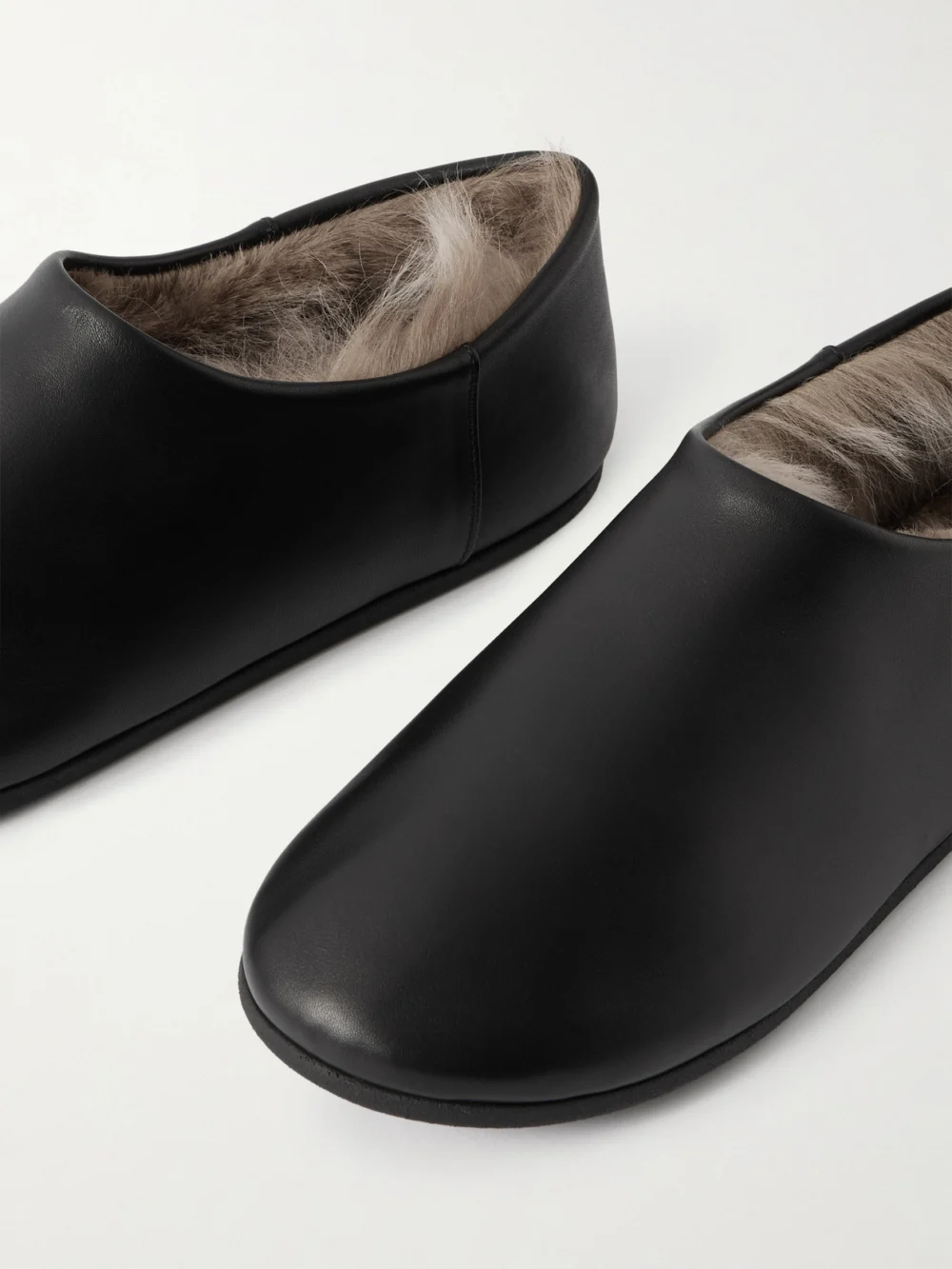 Close-up detail of the Christen Big Boot Shearling-lined Leather Slippers