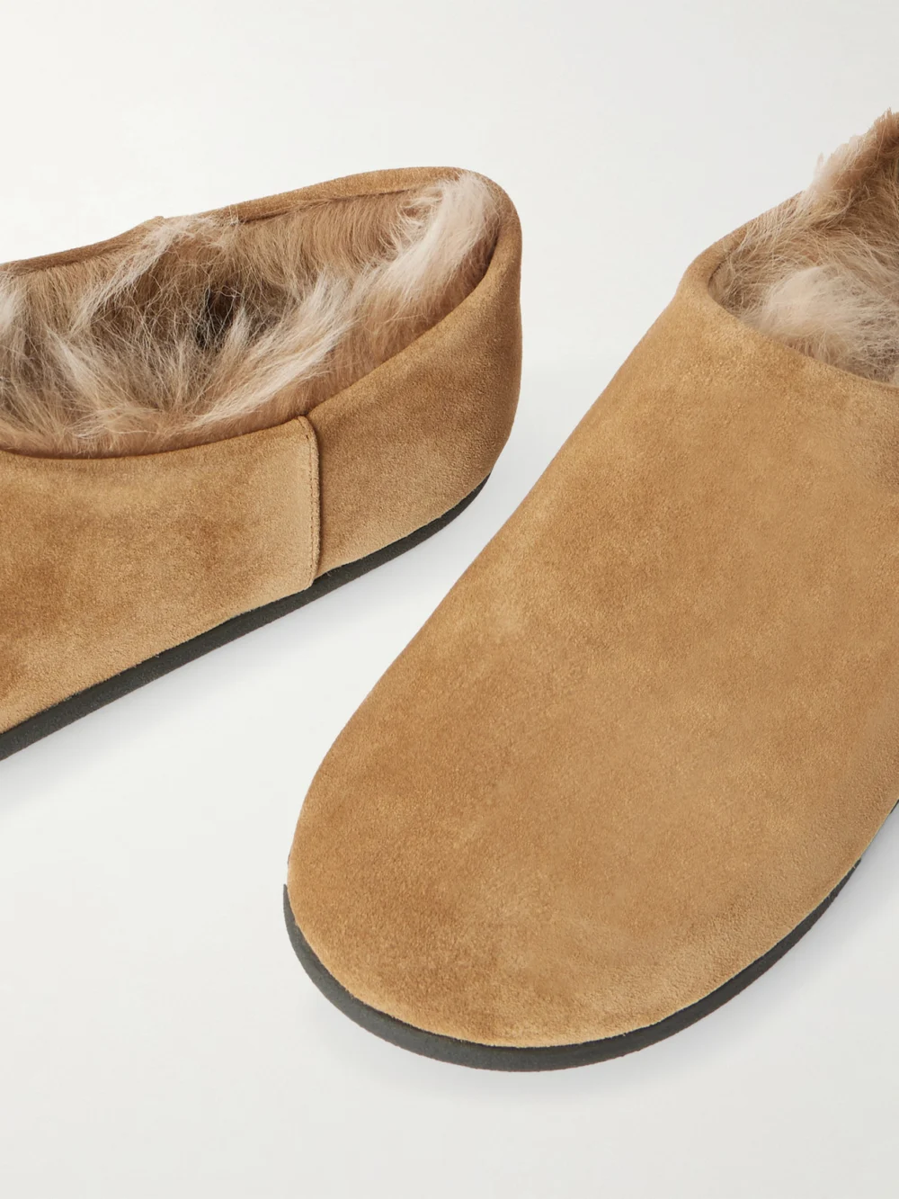 Close-up detail of the Christen Big Bootie Shearling-lined Suede Slippers