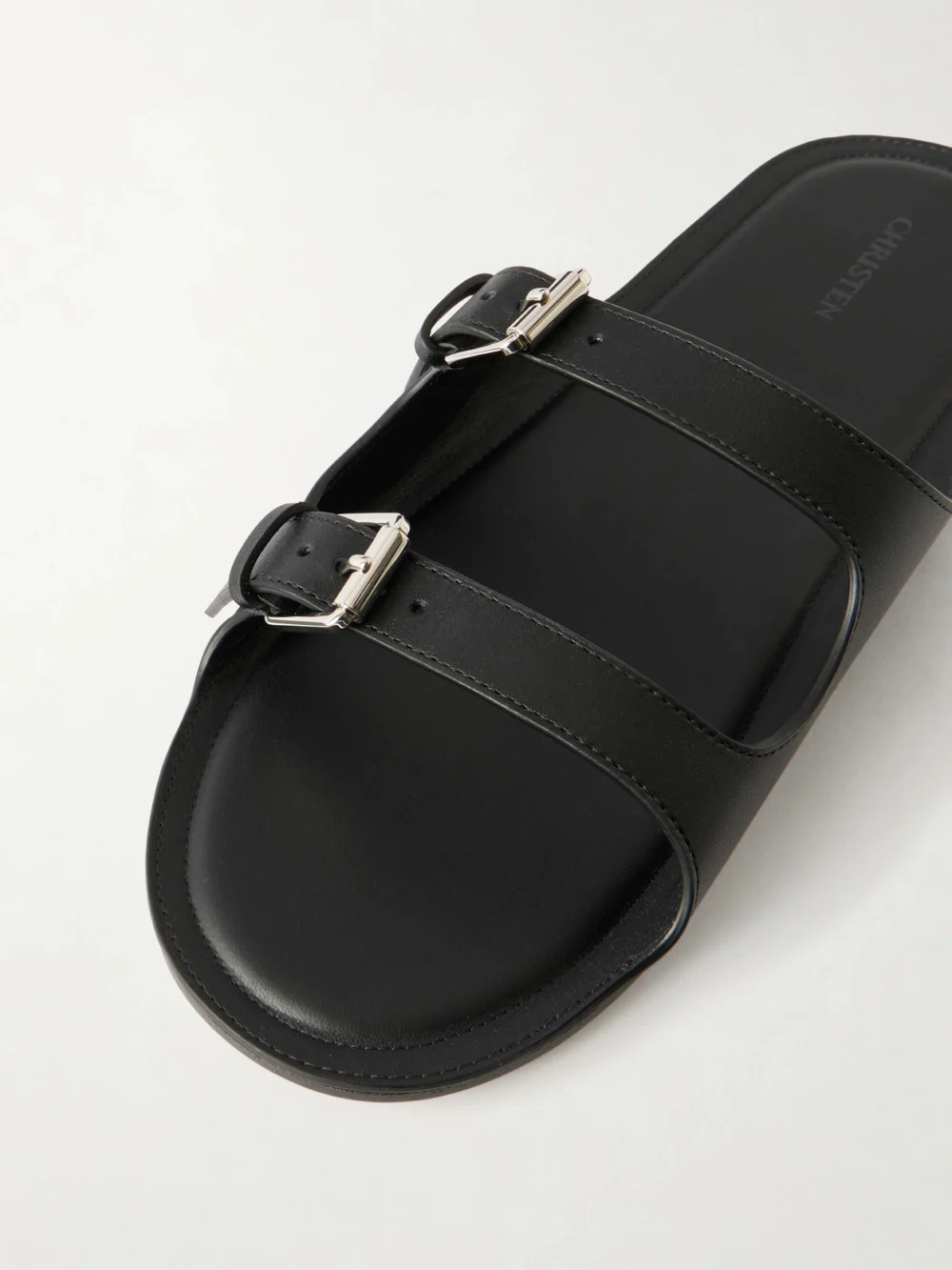 Close-up detail of the Christen Buckled Leather Flat Sandals